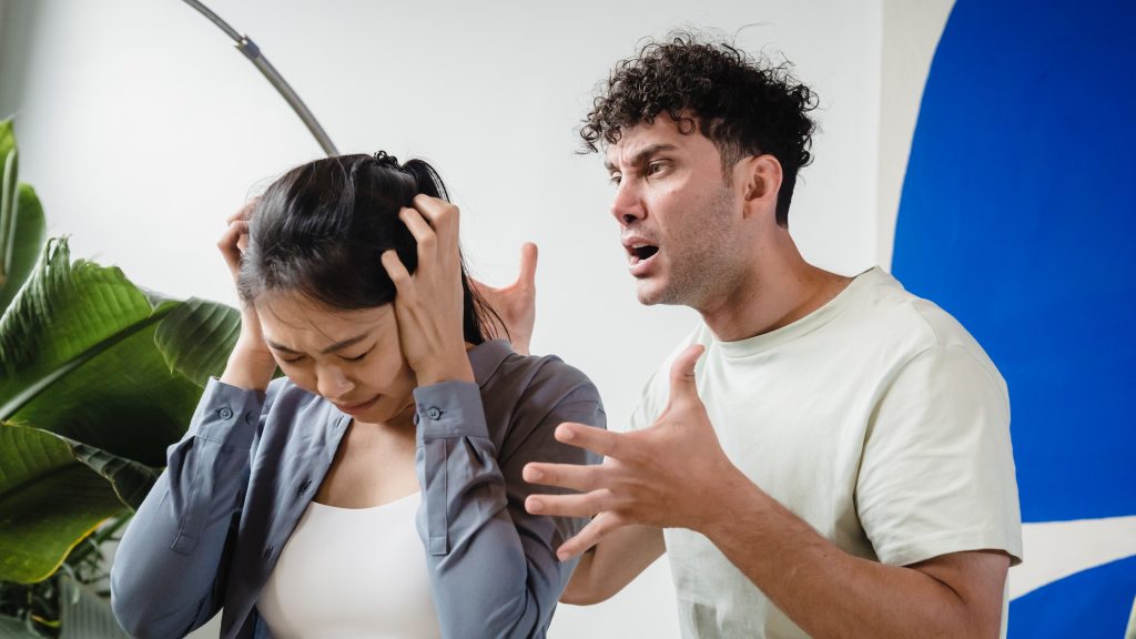a man screaming at his partner