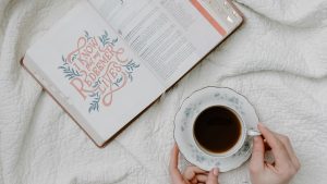 a person having coffee while reading the Bible