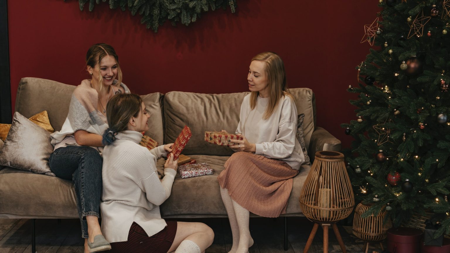 women in the living room holding gifts